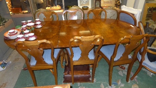 An Italian dining suite comprising oval carved top dining table and eight matching chairs Table W