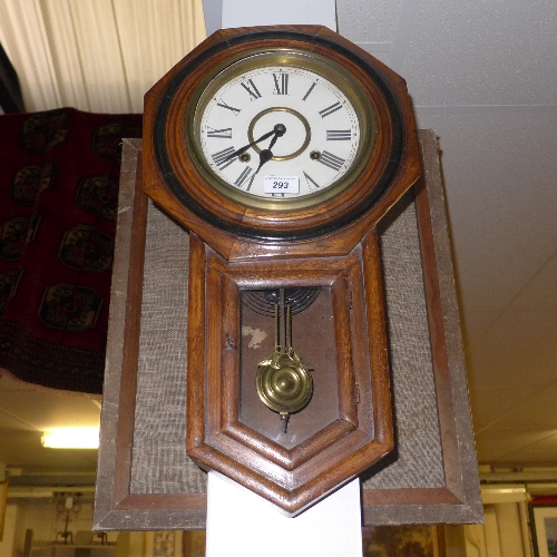 An oak cased wall clock with Roman numeral dial