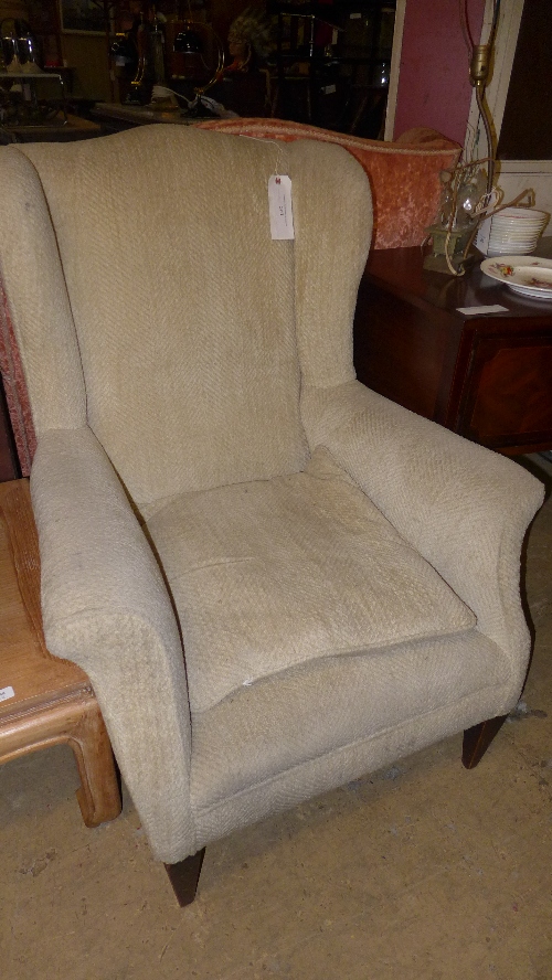 A wine back armchair upholstered in grey fabric
