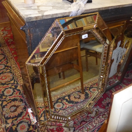 A Venetian style mirror with cushioned border