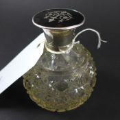 A hallmarked silver and tortoiseshell perfume bottle with a cut glass body