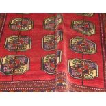 A fine old North East Persian Turkoman carpet repeating elephant foot ghoul motifs on a rouge