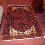 A handmade fine Persian Hamadan rug with three pole medallions on a chocolate field with ivory