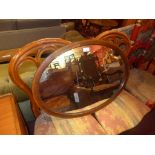 An Edwardian inlaid mahogany mirror with oval plate