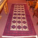 A fine North East Persian Zabir Belouch rug 230 cm x 110 cm repeating panel motifs on an ivory field