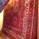 A fine North Eastern Persian Turkoman rug 205 x 110 cm  repeating goul motifs on a rouge field