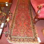 A fine North West Persian Sarouk Mehal runner 295 X 80 cm repeating floral motifs on a terracotta