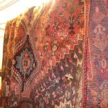 A Persian hand knotted Qashgai carpet the rust coloured ground having quadruple diamond pendants and