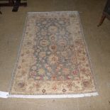 A hand knotted rug the beige ground with allover stylized decoration