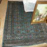 A hand knotted Bokhara rug the green ground with allover allover elephant foot motifs