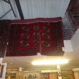 A fine old North East Persian Turkoman carpet repeating elephant foot ghoul motifs on a rouge
