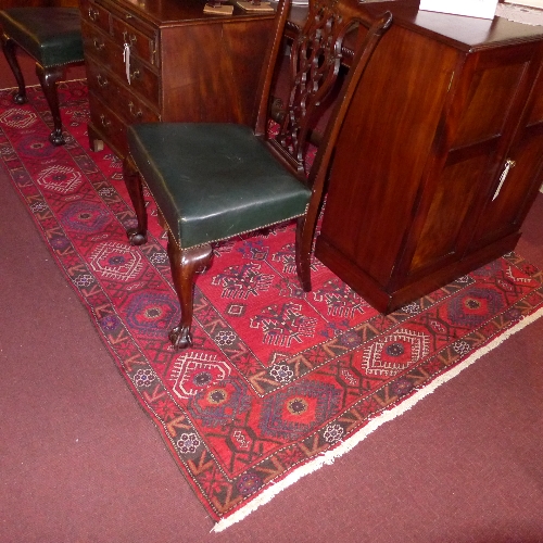 A hand knotted Persian rug the red field with geometric motifs all over in single border