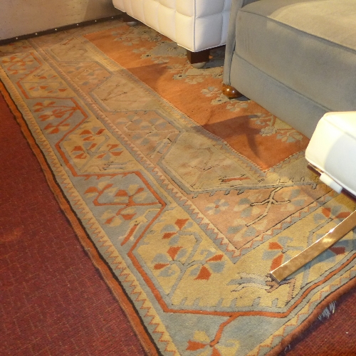 A hand knotted Persian carpet the rust and beige ground with all over repeating floral geometric