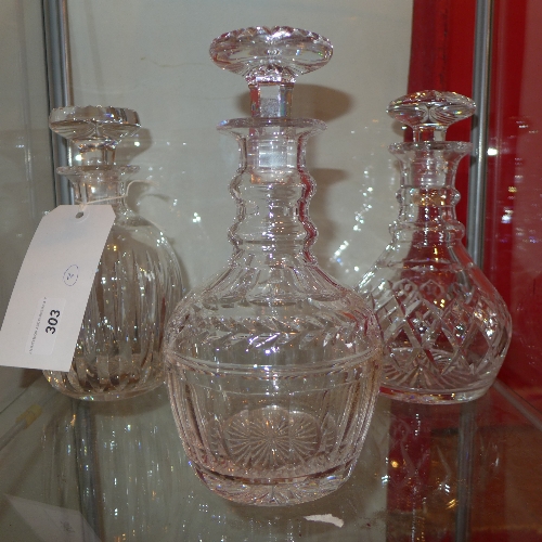 Three cut glass decanters and stoppers