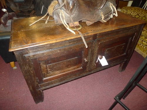 An C18th oak cabinet/coffer of panelled construction with pair of panel doors