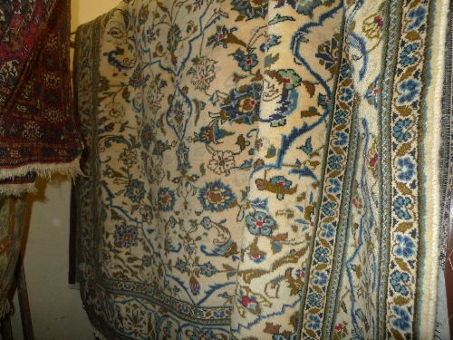 A fine Central Persian Kashan carpet on an ivory field within all over floral motifs L 285 cm x W