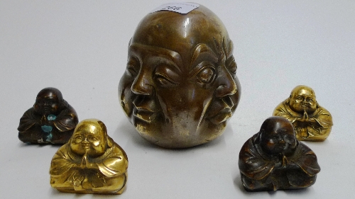 A miniature brass Buddha head showing four expressions together with four seated Buddhas H 5-13 cm