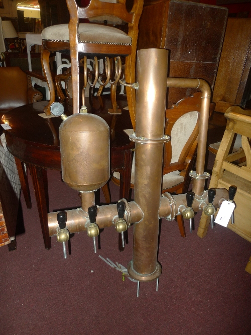 An antique French copper bar top beer dispenser, having bakelite and brass taps W 92 x H 130 cm