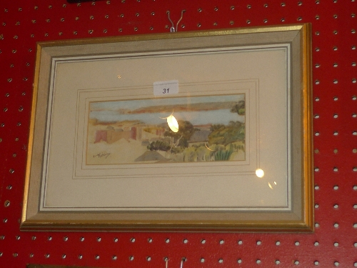 A framed and glazed watercolour Algerian coastal scene with terraced buildings and trees in