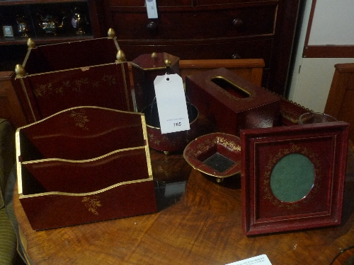 A collection of lacquered boxes heightened in gilt to include letter box, photo frame and trinket