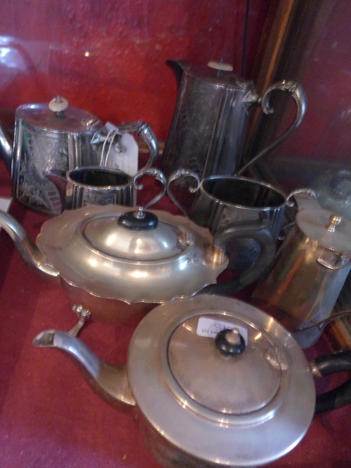 An engraved silver plated four piece tea service and other similar