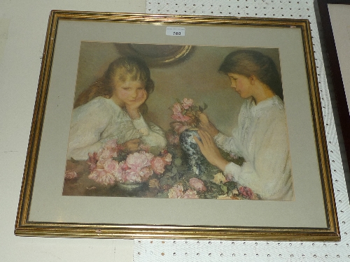 A glazed and framed print of two girls arranging flowers W 40 cm x H 32 cm