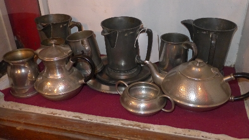 Three antique pewter tankards together with a hammered pewter three piece tea service and similar