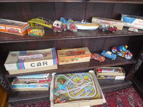 A large collection of tun plate toys including boats, bikes and cars, mainly boxed