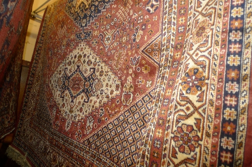 A Caucasian rug the multi coloured field with triple diamond medallion having geometric design