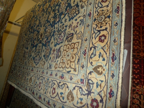 A fine part silk central Persian Nain rug central pole medallion on a sapphire field within stylized