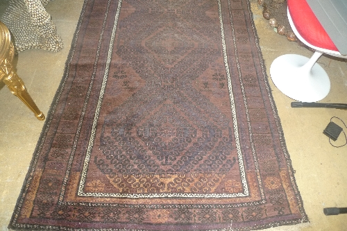 A hand knotted Bokhara rug the brown ground with allover stylized decoration