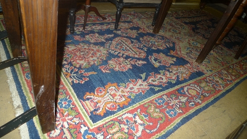 A mid C20th Persian rug with blue ground and floral motifs W 160 L 335 cm