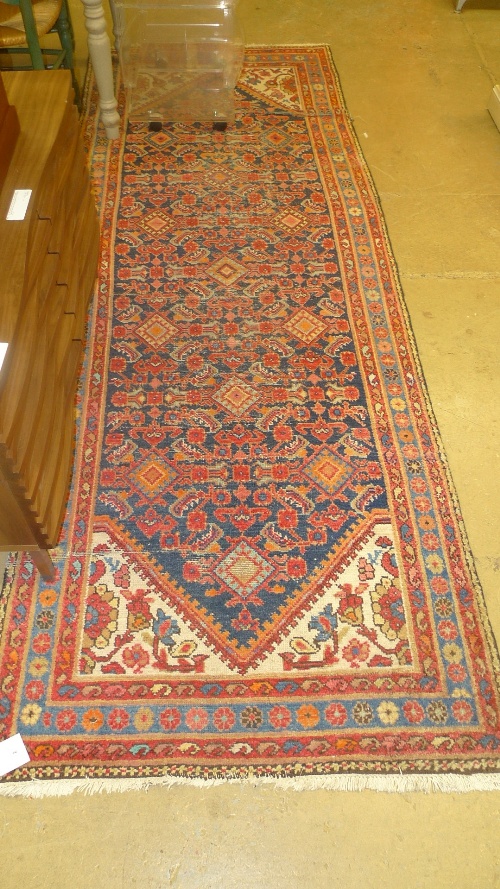 A Persian runner the navy field with allover stylized decoration W 110 H 300 cm