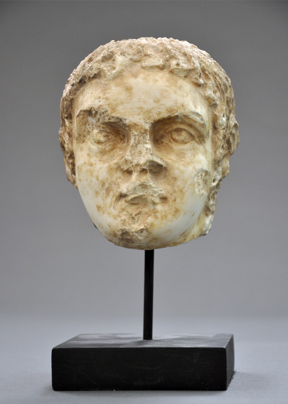 A Roman circa C1st-C2nd AD carved marble head of a nobleman on stand H13cm