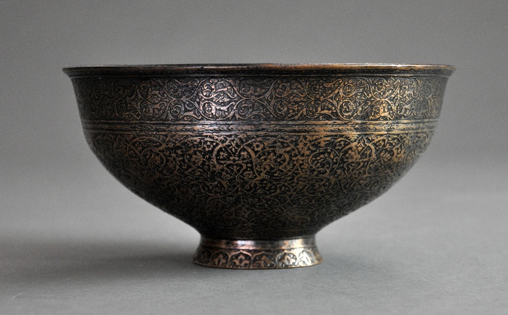 A C17th Persian Safavid tinned copper bowl of deep rounded form with a slightly everted rim rising