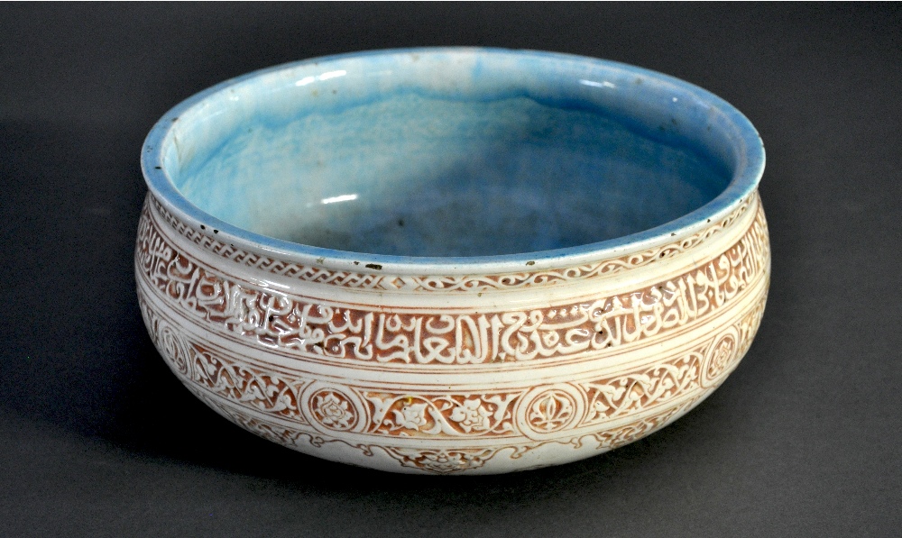 A C19th earthenware glazed bowl with internal turquoise glaze with enamel polychrome outer with