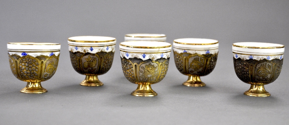 A boxed set of six late C19th Ottoman silver gilt embossed zarfs probably Toughra of Sultan Hamid II