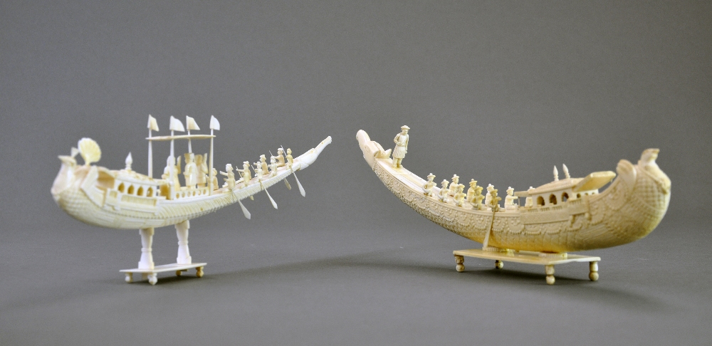 Two large C19th carved ivory boats with traditional rowers and noblemen on stands H 9.5 L 35 cm