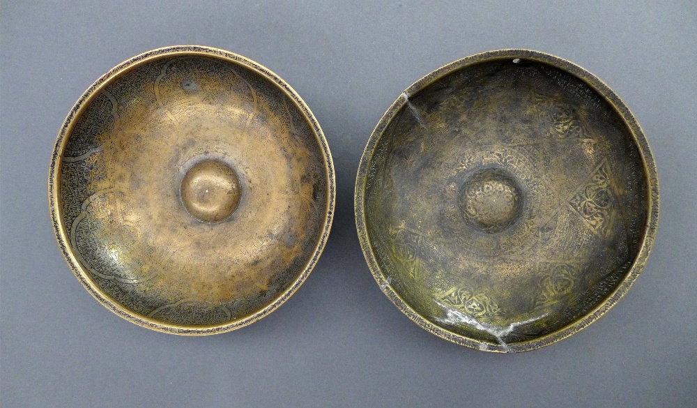 Two C18th/C19th brass Asian / Persian `Magic Bowls` of typical rounded form with engraved decoration