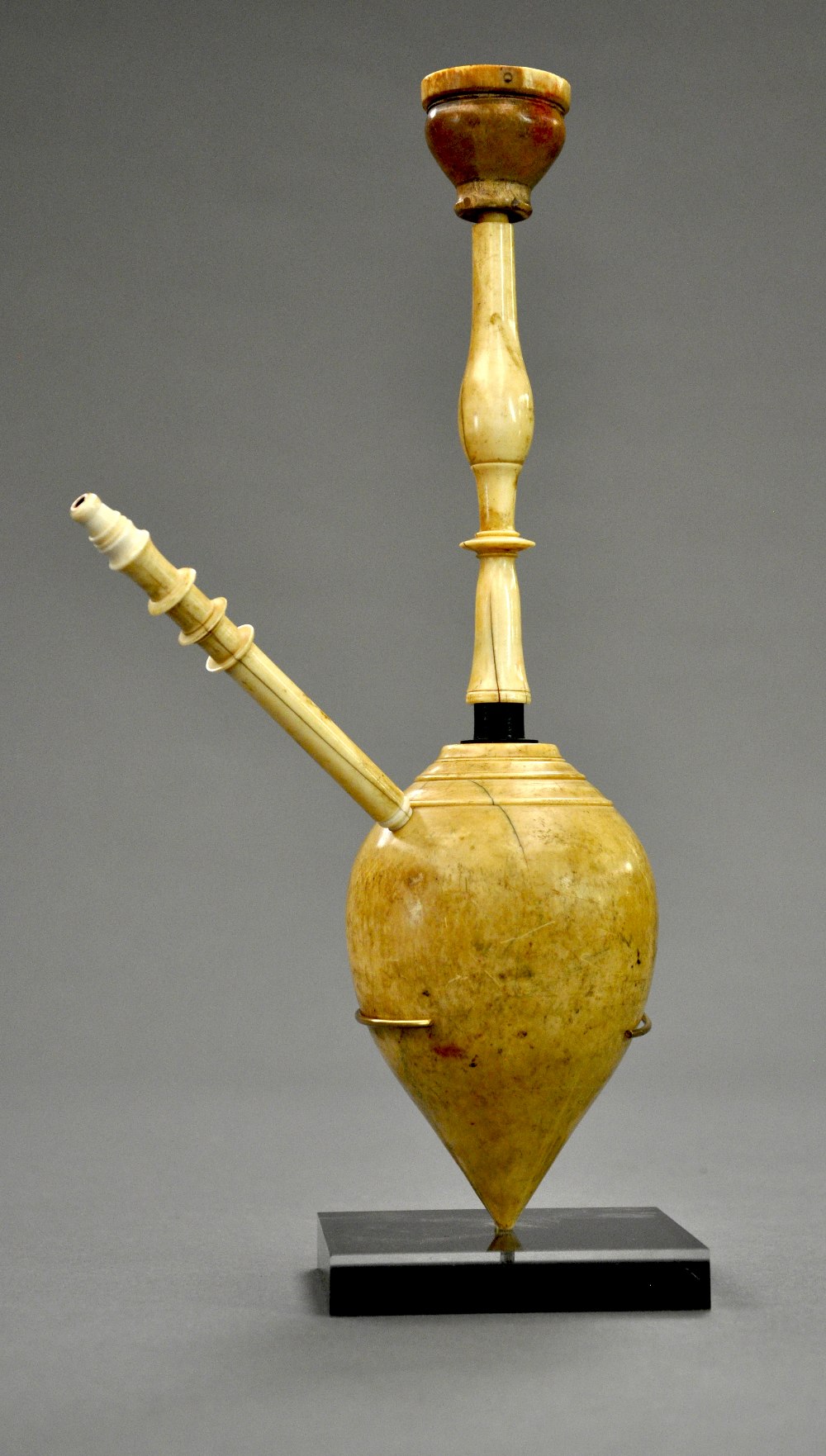 An C18th Indian carved ivory huqqa on stand the tear drop central base with turned pipe connection