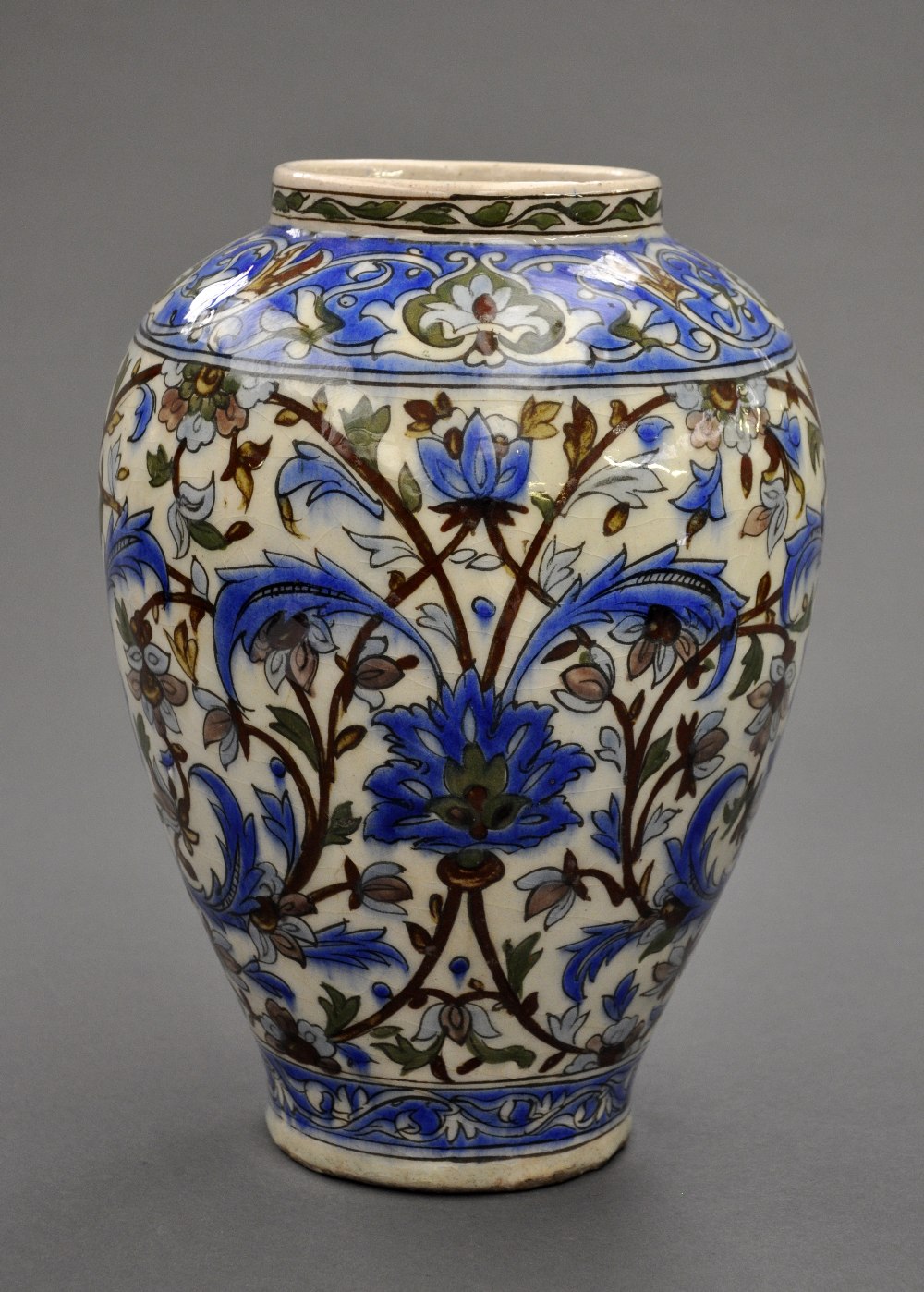 A Qajar C19th decorative bulbous vase brightly glazed with green and cobalt blue with allover