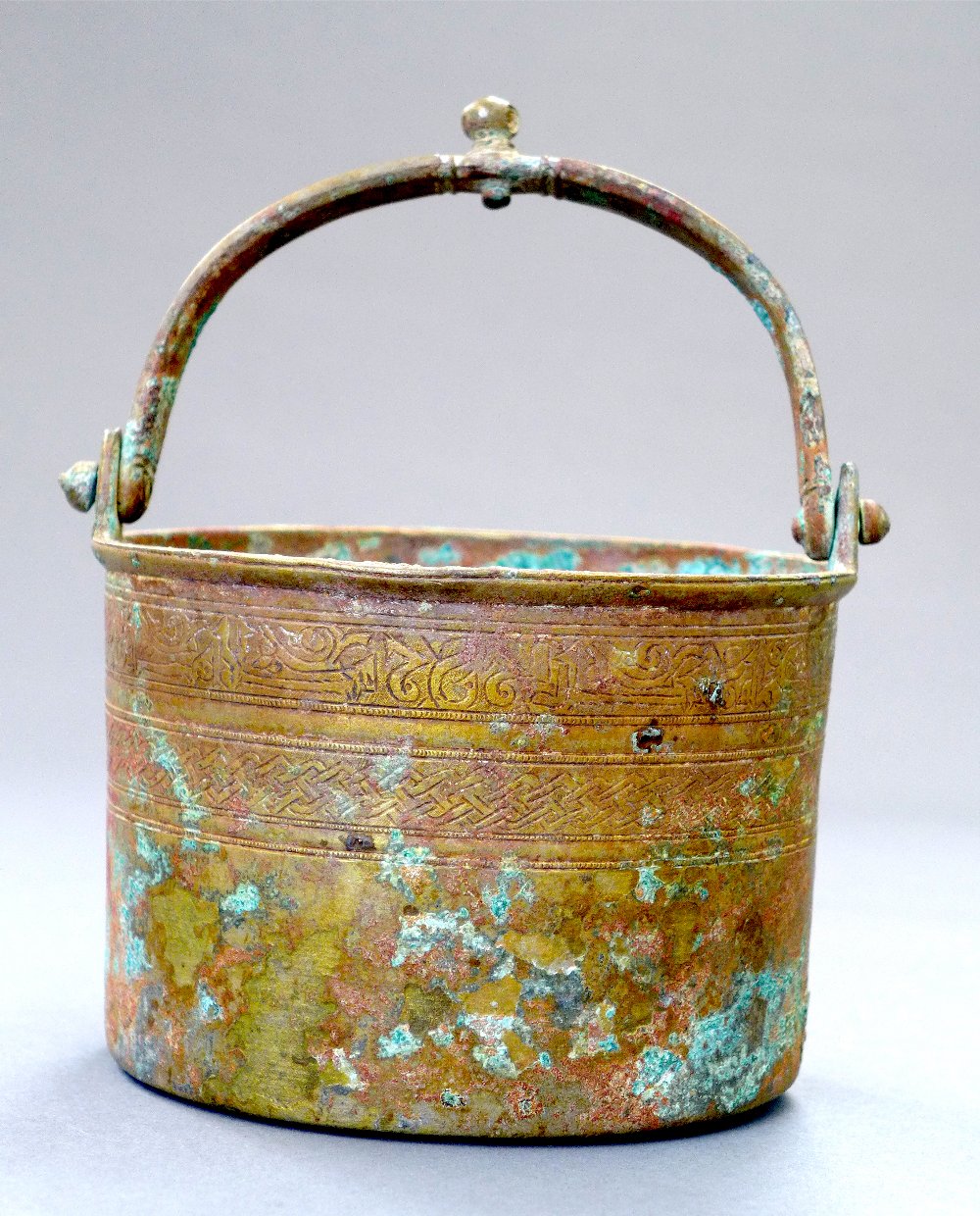 A circa C14th Mumluk bronze bucket with handle decorated with incised calligraphic band above