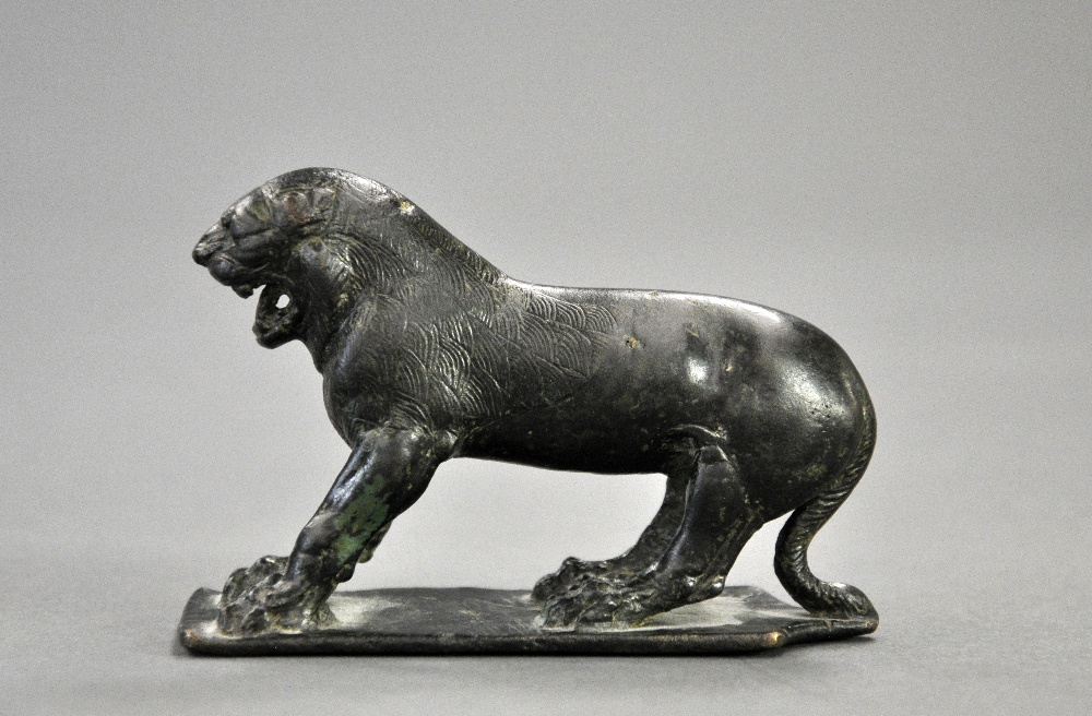 A bronze lion Achaemenid C480-450 BCA Statuette of a bronze lion standing in a defensive position on