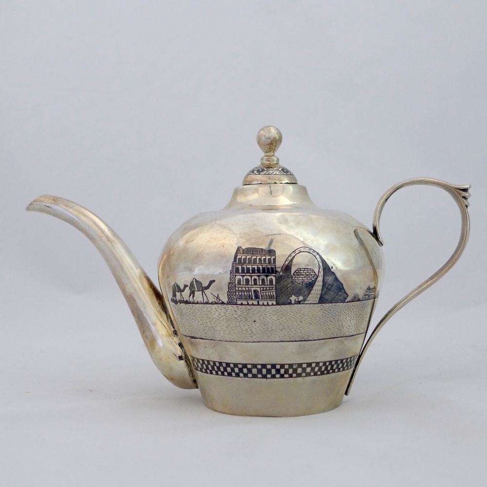 An Iraqi niello silver tea pot decorated with palm trees on river scene with a boat in the