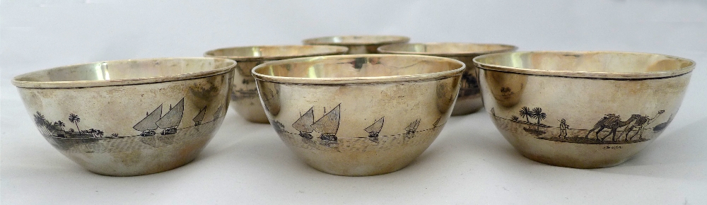 Six  Iraqi niello silver bowls decorated with palm trees on river scene with a boat in the