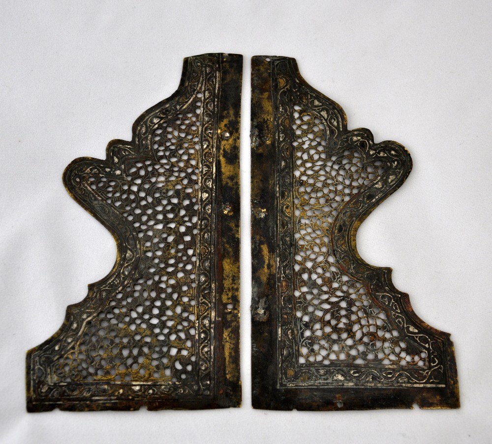 A pair of fine Mamluk circa C14th steel cut corner panels with reticulated centres and floral