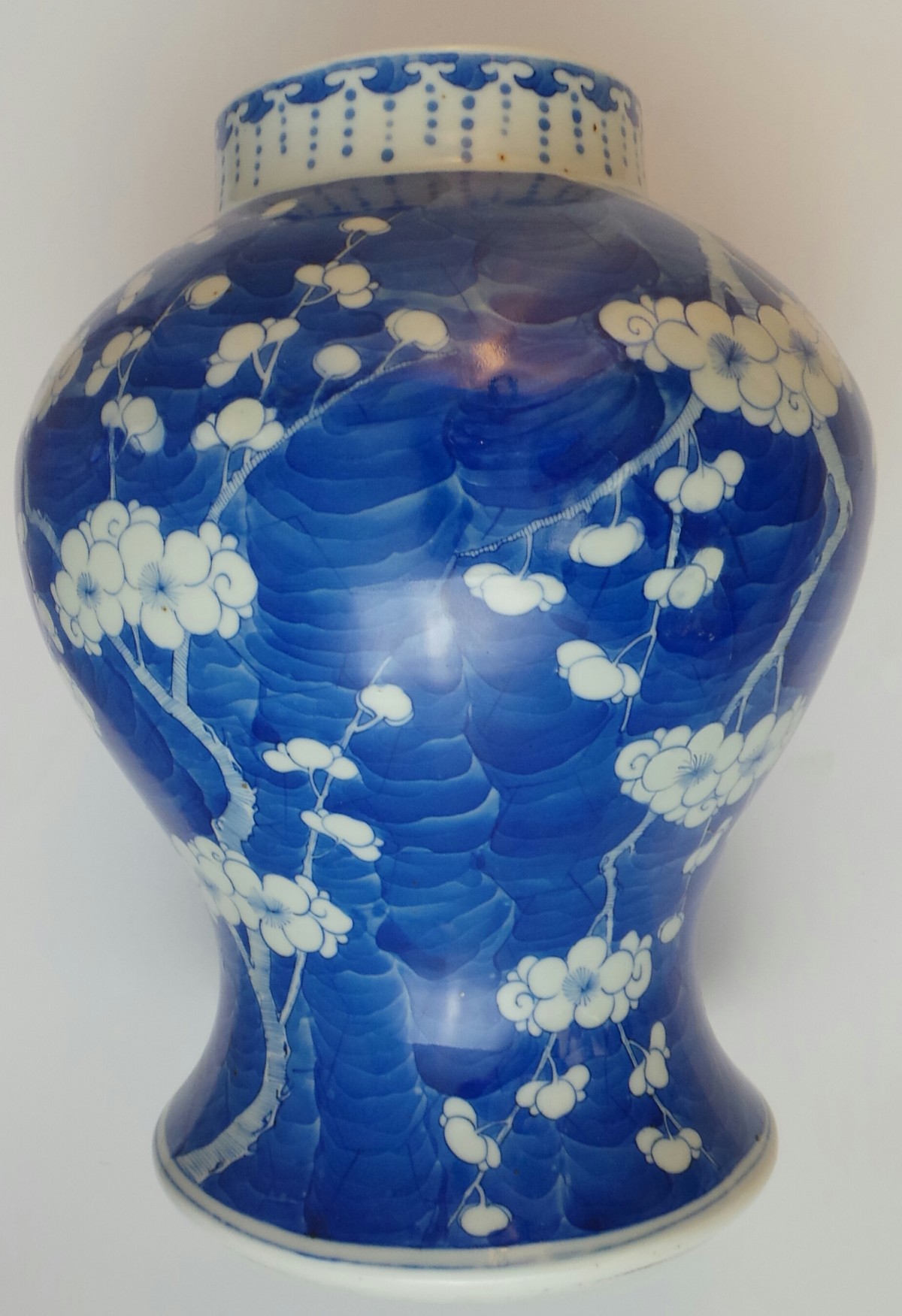 A Chinese Kangxi style blue and white prunus blossom bulbous form vase, with concentric circle