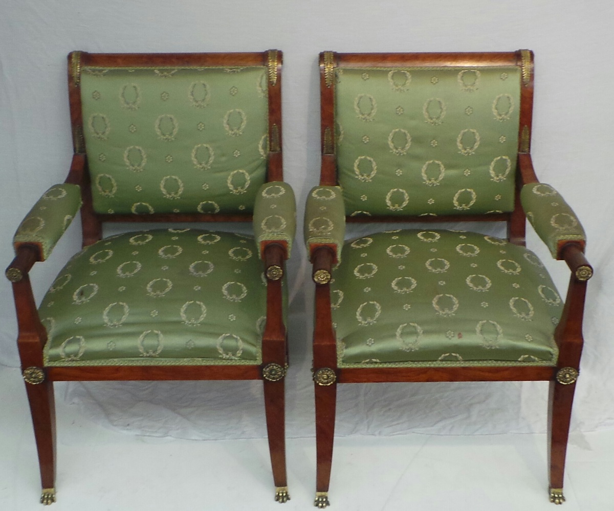 A pair of Empire design walnut open armchairs with pad back above stuff over seat in green fabric on