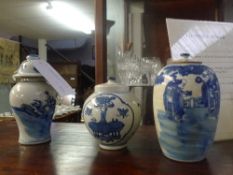 A collection of three Chinese blue and white porcelain vases and covers