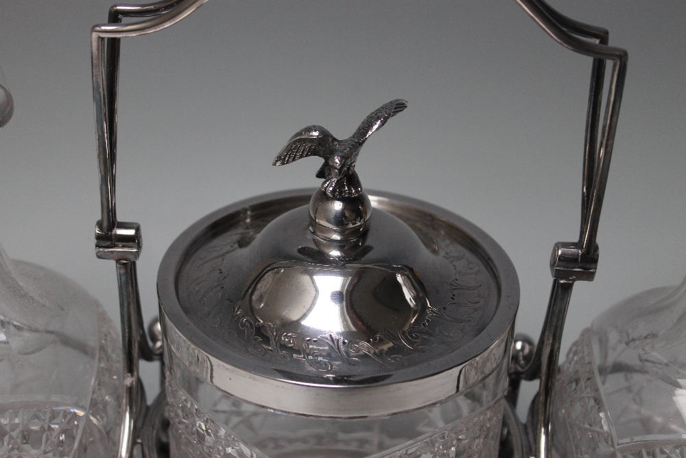 A LATE 19TH CENTURY `WALKER & HALL` SILVER PLATED TANTALUS, with two cut glass decanters and - Image 2 of 3